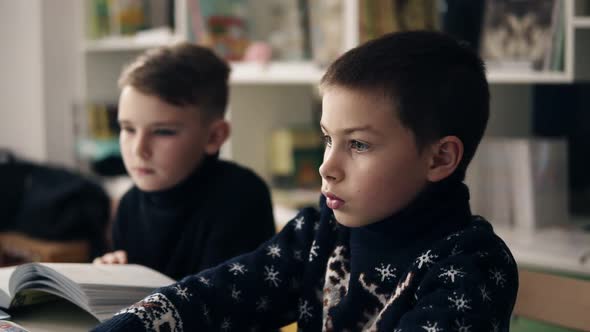 Slow Motion Footage of Two Little Boys Sitting in Front of Their Laptops