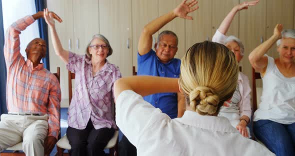 Doctor teaching exercise to senior people 4k