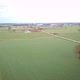 Aerial View of a Field with a Winding Asphalt Country Road Shot with a Drone - VideoHive Item for Sale