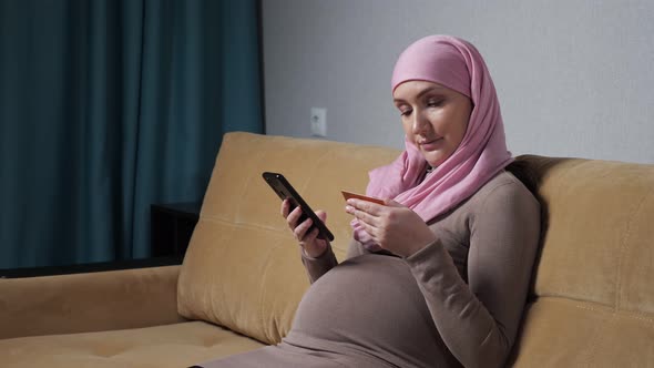 Pregnant Woman in Hijab Checks Number and Makes Phone Call