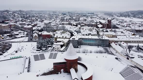 Drone flying towards Kaunas castle in high angle winter season shot