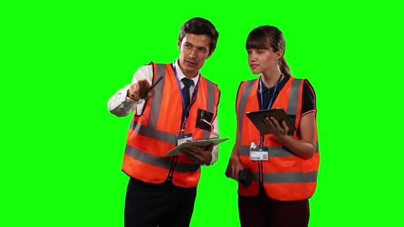 Front view of a site workers using digital tablet with green screen