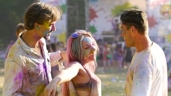 Cheerful Young Men and Woman Having Fun at Concert, Friends Colored With Powder