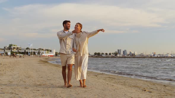 Happy Couple Walking Along Summer Beach