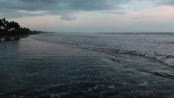 People on the Ocean at High Tide in Indonesia