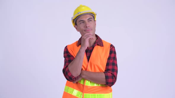 Young Happy Hispanic Man Construction Worker Thinking