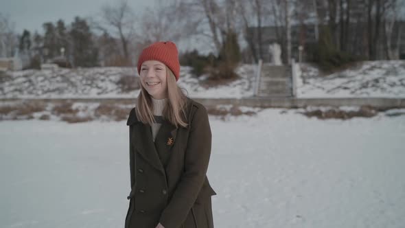 Girl in a Coat Walks Along Winter Street, Happy Winter Day