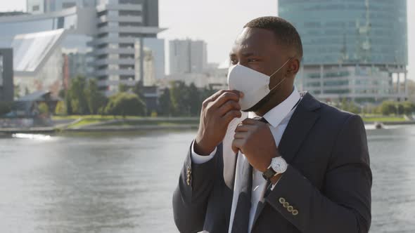 Afro Businessman Wearing Face Mask Outside