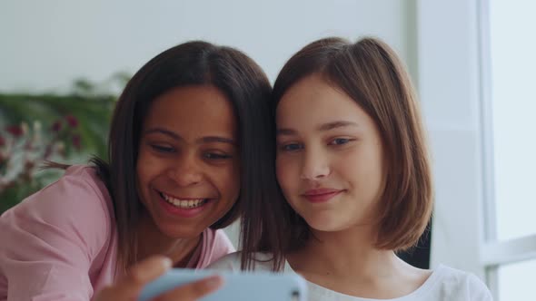 Handsome sisters doing selfie on phone