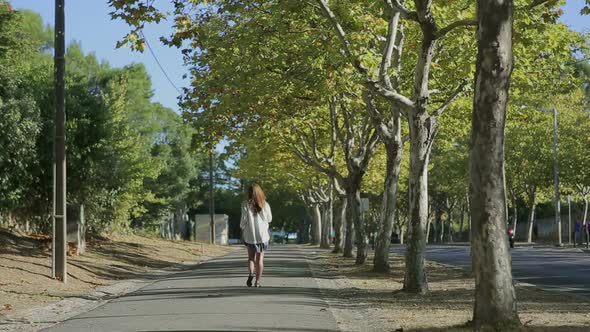 Girl Walking Throught Cork Tree Alley Street Portugal