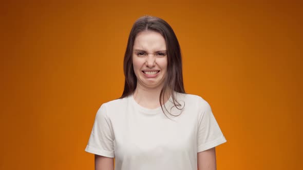 Young Woman Expressing Aversion Rejection Negative Attitude Against Yellow Background