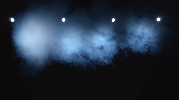 Installation Takes a Smoke on a Dark Stage Illuminated By a Bright Floodlight