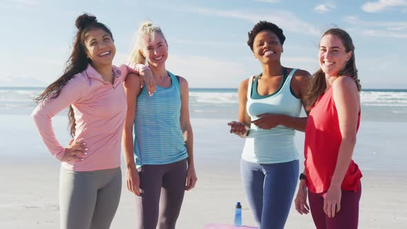 Portrait of happy group of diverse female friends having fun at the beach