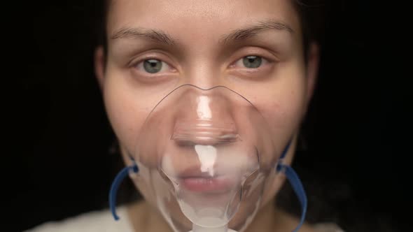 Close-up of the face of a young woman who treats the respiratory tract
