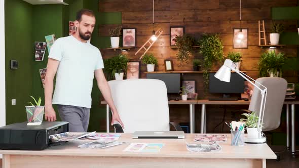 Creative Director Arriving at the Office and Opening His Laptop