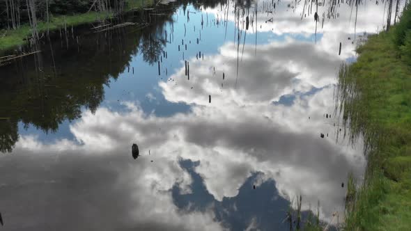 Summer Aerial Drone View Of Ceder Pond With Cloud Reflections In Water