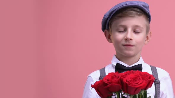 Cute Gentleman With Bunch of Roses Looking Into Camera, Preparing for Date