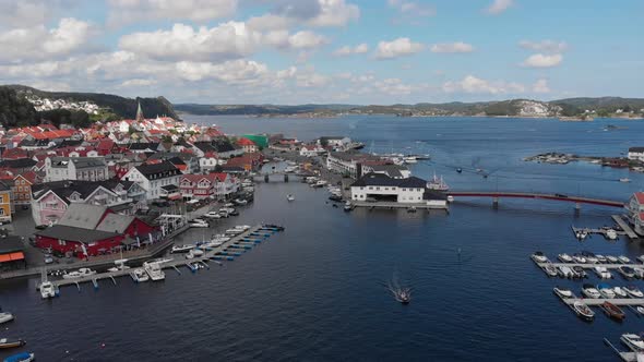 Slow aerial pan showing quaint coastal village and its marina, Scandinavia