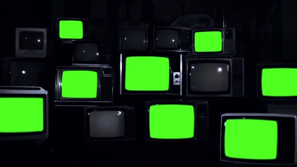 Pile of Retro TVs Green Screen on Dark Background. Black and White Tone.