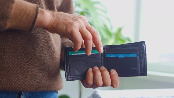 Close Up of a Old Man Hands Take Out Dollar Bills From Wallet