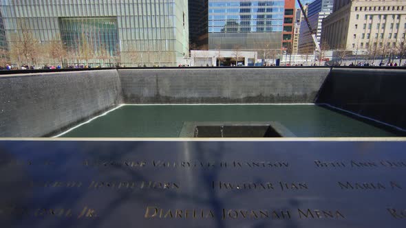 Victims names written on the memorial pool in 9/11 Park