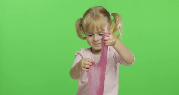 Kid Playing with Hand Made Toy Slime. Child Having Fun Making Pink Slime