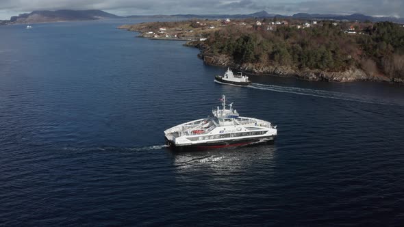 Aerial shot over Electric passenger ferry meeting old diesel ferry from 1968 - Norway