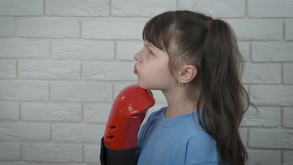 Child in Red Box Gloves