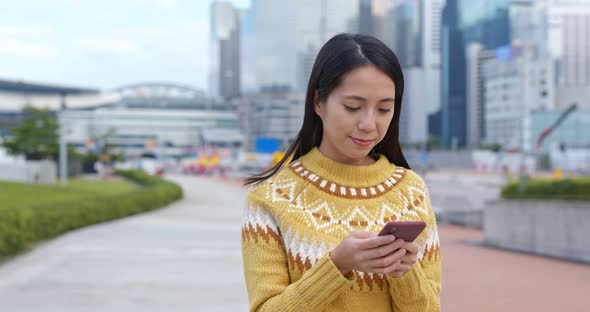 Woman work on mobile phone in city