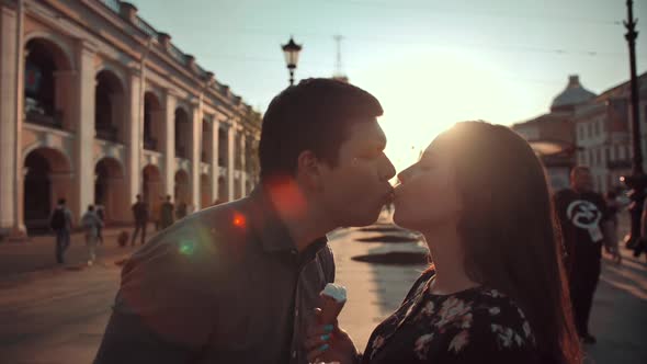 Happiness Couple with Ice Cream Under Sunlight at Evening Sunset