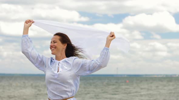 Happy Woman with Shawl Waving in Wind on Beach 27