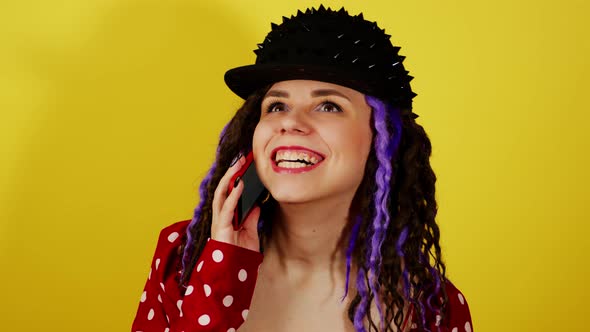 Young Handsome Smiling Woman in Black Cap Talking on Mobile Phone