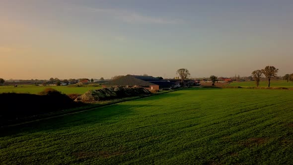 Aerial Cinematic Clip Drone Flying Over a Farm Field During Sunset