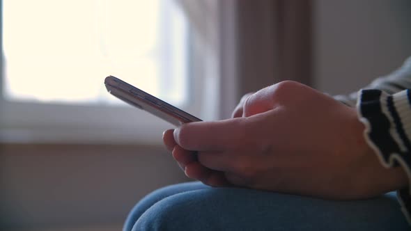 Female using modern smartphone for online communication during lockdown in 4k video