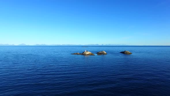 Small rocky islands with lighthouse in the sea