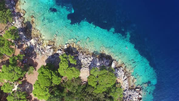 Aerial view of turquoise shallows contrasted with deep sea