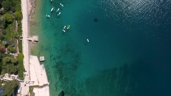 Aerial view of people kayaking near pier at the ocean, Mali Losinj, Croatia.