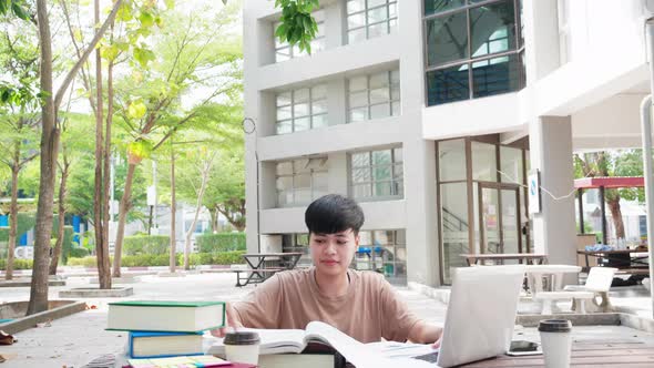 Asian student preparing exam and learn lessons in work space at university