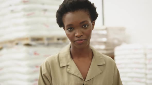 Portrait of young woman working in a warehouse strore room 4k