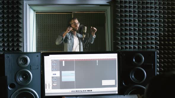 Male Singer Performing Song in Recording Studio