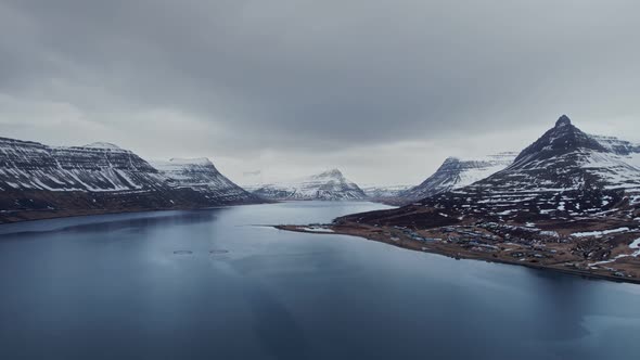 Breathtaking aerial view over winter landscape in the arctic sea and beautiful snowy mountains in We