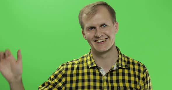 Handsome Caucasian Man Waves and Saluting on Green Screen Chroma Key