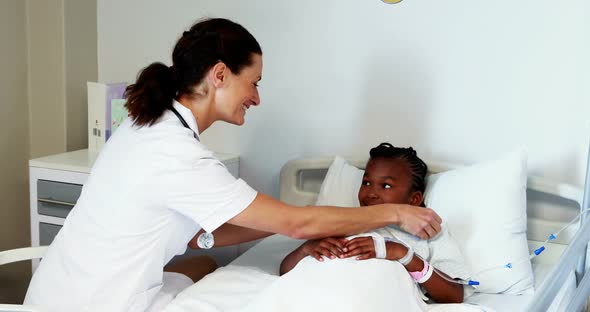 Female doctor consoling sick girl