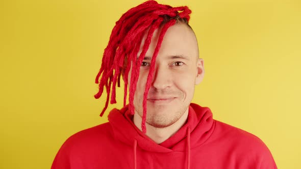 Young Man with Red Dreadlocks Looking at Camera