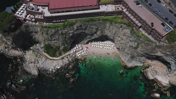 Cinematic tilting upward drone shot of Isola Bella flying coastline. Also known as The Pearl of the