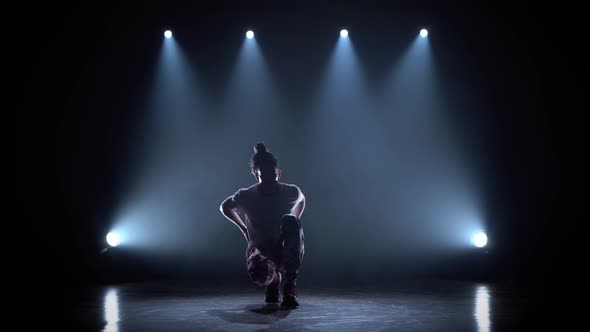 Man Enjoying Hip Hop Moves in Dark Studio with Smoke and Lighting