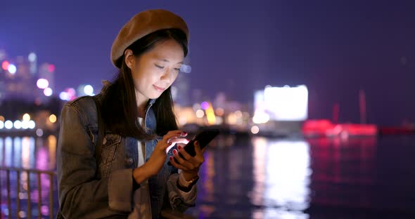 Young woman use of mobile phone at night