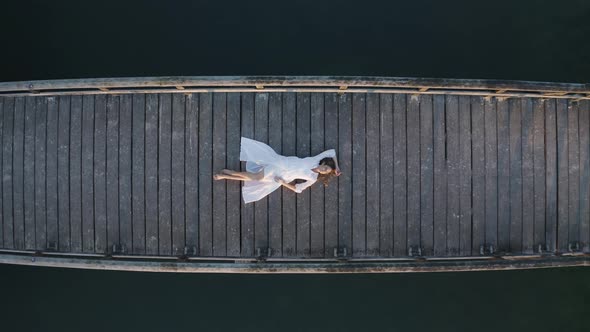 Arial view of a woman on the bridge at Henschotermeer lake.