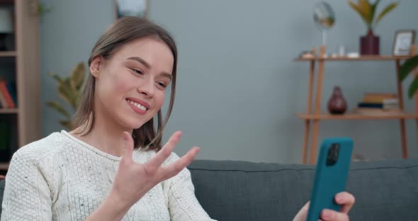 Crop View of Deaf Woman Having Video Conversation and Showing with Sign Language Phrase Fine News