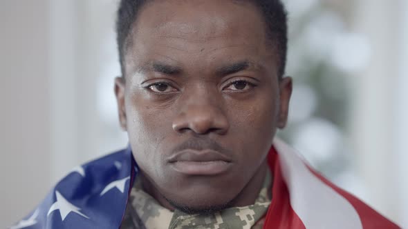 Headshot of Confident Brave African American Soldier Posing at Home with USA Flag